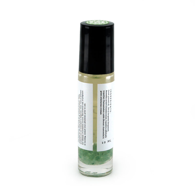 Heart Chakra roller bottle showing back of label and green aventurine crystals. Soul Ritual chakra roller bottle collection for heart chakra infused with reiki, green aventurine crystals, and chakra essential oil blend for your energetic well-being,