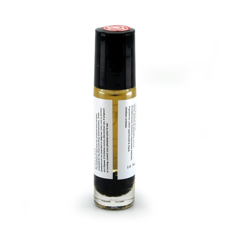 Root Chakra roller bottle showing label and crushed black obsidian gemstones. Soul Ritual chakra roller bottle collection for root chakra infused with reiki, black obsidian and chakra essential oil blend for your energetic well-being.