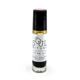 Root Chakra roller bottle showing label and crushed black obsidian gemstones. Soul Ritual chakra roller bottle collection for root chakra infused with reiki, black obsidian and chakra essential oil blend for your energetic well-being.