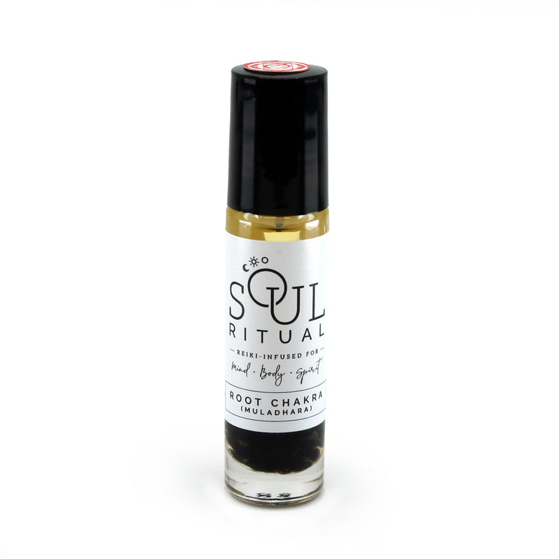 Root Chakra roller bottle showing label and crushed black obsidian gemstones. Soul Ritual chakra roller bottle collection for root chakra infused with reiki, black obsidian and chakra essential oil blend for your energetic well-being.
