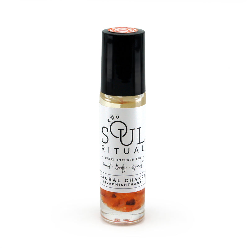 Sacral Chakra roller bottle showing label and crushed carnelian gemstones. Soul Ritual chakra roller bottle collection for sacral chakra infused with reiki, carnelian and chakra essential oil blend for your energetic well-being.