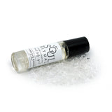  Third Eye Chakra roller bottle laying on crushed clear quartz crystals. Soul Ritual chakra roller bottle collection for Third Eye chakra infused with reiki, clear quartz and chakra essential oil blend for your energetic well-being.